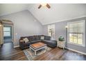 Cozy living room with a plush sectional, hardwood floors, and natural light, ideal for relaxation at 839 Prestwick Dr, Rock Hill, SC 29730