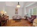 Cozy living room with hardwood floors, decorative chandelier, and comfortable seating arrangement at 8724 Highgrove St, Charlotte, NC 28277