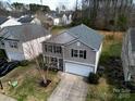 Well-maintained two-story home in a suburban neighborhood featuring an attached two-car garage at 10114 Turkey Point Dr, Charlotte, NC 28214