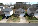 Suburban two-story home featuring a well-manicured lawn and a convenient two-car garage at 10114 Turkey Point Dr, Charlotte, NC 28214