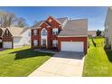 Attractive brick home with an attached two-car garage and well-maintained landscaping in a neighborhood setting at 10146 Spring Park Dr, Charlotte, NC 28269