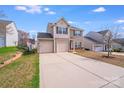 The home features a two car garage and long driveway at 105 Abel Peterson Dr, Mount Holly, NC 28120
