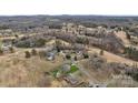 Wide aerial view showing a home nestled in a neighborhood, surrounded by trees at 107 Pinelake Dr, Kings Mountain, NC 28086
