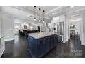 Open-concept kitchen with stainless appliances, island seating, and open view to the cozy living room at 1122 Hartmann Ct, Fort Mill, SC 29715