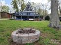 An A-Frame home nestled in nature, highlighted by an inviting fire pit for outdoor relaxation at 120 Ole Point Ln, Salisbury, NC 28146