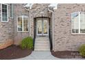 Charming front entrance with double doors and brick facade at 121 Dabbling Duck Cir, Mooresville, NC 28117