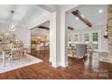 Spacious living area with hardwood floors, exposed beams, and a cozy fireplace at 121 Dabbling Duck Cir, Mooresville, NC 28117