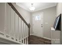 Welcoming entryway features hardwood floors, a stylish staircase, and a modern light fixture at 12312 Landry Renee Pl # 35, Charlotte, NC 28277