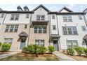 Townhome exteriors boasting brick and siding details, enhanced by manicured greenery at 12312 Landry Renee Pl # 35, Charlotte, NC 28277