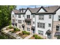 Charming townhome exteriors with brick and siding, complemented by lush landscaping at 12312 Landry Renee Pl # 35, Charlotte, NC 28277