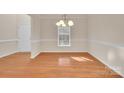 Bright dining room showcasing hardwood floors and elegant trim work at 12724 Hunting Birds Ln, Charlotte, NC 28278