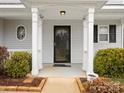 Inviting front porch featuring white columns, tasteful landscaping, and a secure front door at 13108 Rothe House Rd # 167, Charlotte, NC 28273