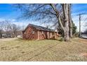 Quaint brick home surrounded by a well-maintained lawn and mature trees at 1407 17Th Ne Ave, Hickory, NC 28601
