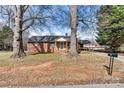 Charming brick home with mature trees, a wheelchair ramp, and convenient mailbox at the street at 1407 17Th Ne Ave, Hickory, NC 28601