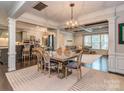 Elegant dining room featuring a modern chandelier, stylish furniture and view to kitchen and living area at 1708 Royal Gorge Ave, Charlotte, NC 28210