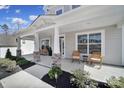 Inviting front porch with stone accents, rocking chairs, and professionally landscaped surroundings at 17111 Monocacy Blvd, Huntersville, NC 28078