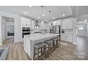 Bright, open kitchen featuring a large island, quartz countertops, stainless steel appliances, and ample cabinet space at 17111 Monocacy Blvd, Huntersville, NC 28078