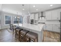 Bright, open kitchen featuring a large island, quartz countertops, stainless steel appliances, and ample cabinet space at 17111 Monocacy Blvd, Huntersville, NC 28078