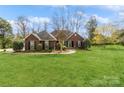 Inviting brick home with lush green lawn and beautiful landscaping enhancing curb appeal at 2019 W Laporte Dr, Charlotte, NC 28216