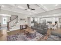 Open-concept living room with hardwood floors, coffered ceilings, and modern furniture at 233 Catawba Crest Ln, Clover, SC 29710