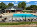 Community pool area with lounge chairs and fencing, perfect for relaxation at 3300 Savannah Way, Monroe, NC 28110