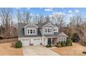 Charming two-story home boasts a two-car garage, neutral paint and manicured landscaping at 3549 Sandy E Trl, Fort Mill, SC 29707