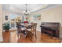 Dining room with a wood table, bay window, and piano at 3815 10Th Ne St, Hickory, NC 28601