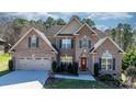Charming brick home with a well-manicured lawn, arched doorway, and a two-car garage at 3815 10Th Ne St, Hickory, NC 28601