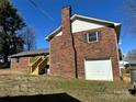 Brick home with a deck and garage in the backyard at 408 E Ryder Ave, Landis, NC 28088