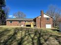 Spacious backyard featuring a deck, garage, and brick exterior at 408 E Ryder Ave, Landis, NC 28088
