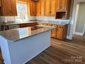 Updated kitchen featuring granite countertops, stainless steel appliances, and wood floors at 408 E Ryder Ave, Landis, NC 28088