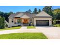 Beautiful white brick home with a two-car garage, a covered porch and manicured lawn at 4808 1St Nw St, Hickory, NC 28601