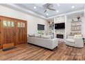 Cozy living room with wood floors, stone fireplace, modern furniture, and double wooden doors at 4808 1St Nw St, Hickory, NC 28601