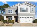 Two-story home featuring gray siding, white trim, and a two-car garage at 5703 Eleanor Rigby Rd, Charlotte, NC 28278