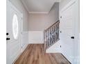 Elegant foyer with hardwood floors, a staircase with decorative iron railings, and a well-lit, welcoming space at 588 Washington Ln, Albemarle, NC 28001