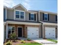 New townhome exterior showing brick accents, attached garages, and professional landscaping at #603 Mt. Mitchell Ave # 603, Gastonia, NC 28052