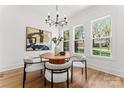Bright dining room featuring a modern chandelier and a round table with seating for four at 621 Poindexter Dr, Charlotte, NC 28209