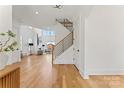 Bright foyer with hardwood floors, modern staircase, and view to the living room at 621 Poindexter Dr, Charlotte, NC 28209