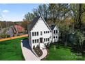 Beautiful, modern farmhouse with striking curb appeal, complemented by a lush green lawn and manicured landscaping at 621 Poindexter Dr, Charlotte, NC 28209