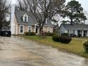 View of house with car in driveway on an overcast day. Well-maintained lawn and landscaping add to curb appeal at 7310 Yorkville Ct, Charlotte, NC 28273