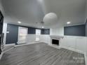Bright and open living room features luxury vinyl plank flooring, modern recessed lighting, and a stylish fireplace at 7310 Yorkville Ct, Charlotte, NC 28273