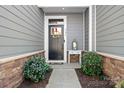 Inviting front door with wreath, stylish decor, and manicured bushes creating a welcoming entrance at 781 Hazel Way, Denver, NC 28037