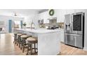 Modern kitchen with white cabinets, stainless steel appliances, large island, and breakfast bar seating at 781 Hazel Way, Denver, NC 28037