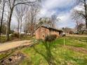 Home featuring a spacious backyard, fenced perimeter, and mature trees, perfect for outdoor activities and privacy at 905 Kemper Cir, Rock Hill, SC 29732