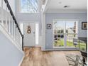 Bright foyer with hardwood floors, a staircase, and large windows providing ample natural light at 9523 Stawell Dr, Huntersville, NC 28078