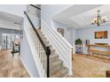 Hallway with staircase, neutral walls, and decorative lighting leading to other living spaces at 9523 Stawell Dr, Huntersville, NC 28078