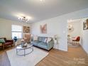 Comfortable living room featuring a plush sofa, a coffee table with decor, and ample natural light at 1057 Farm Pond Ln, Rock Hill, SC 29732
