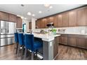 Stylish kitchen island with barstool seating, wood cabinetry, and modern lighting fixtures at 1195 Cavalier Ln, Rock Hill, SC 29730