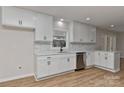 Beautiful white kitchen boasts modern cabinets, stainless steel appliances, and stylish backsplash at 1356 Ford Dr, Lowell, NC 28098