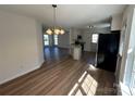 Open-concept kitchen featuring stainless steel appliances, a granite countertop island, and wood-look flooring at 2190 Pacer Rd, Lancaster, SC 29720